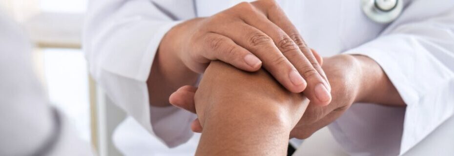 Doctor Supporting Patient By Holding Hand