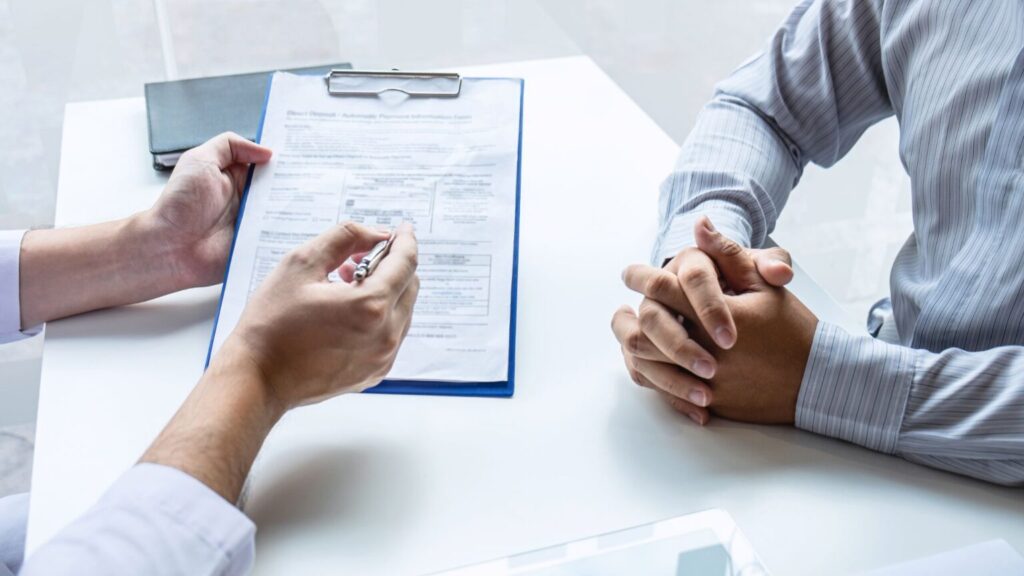 Doctor Writing Prescription For Patient