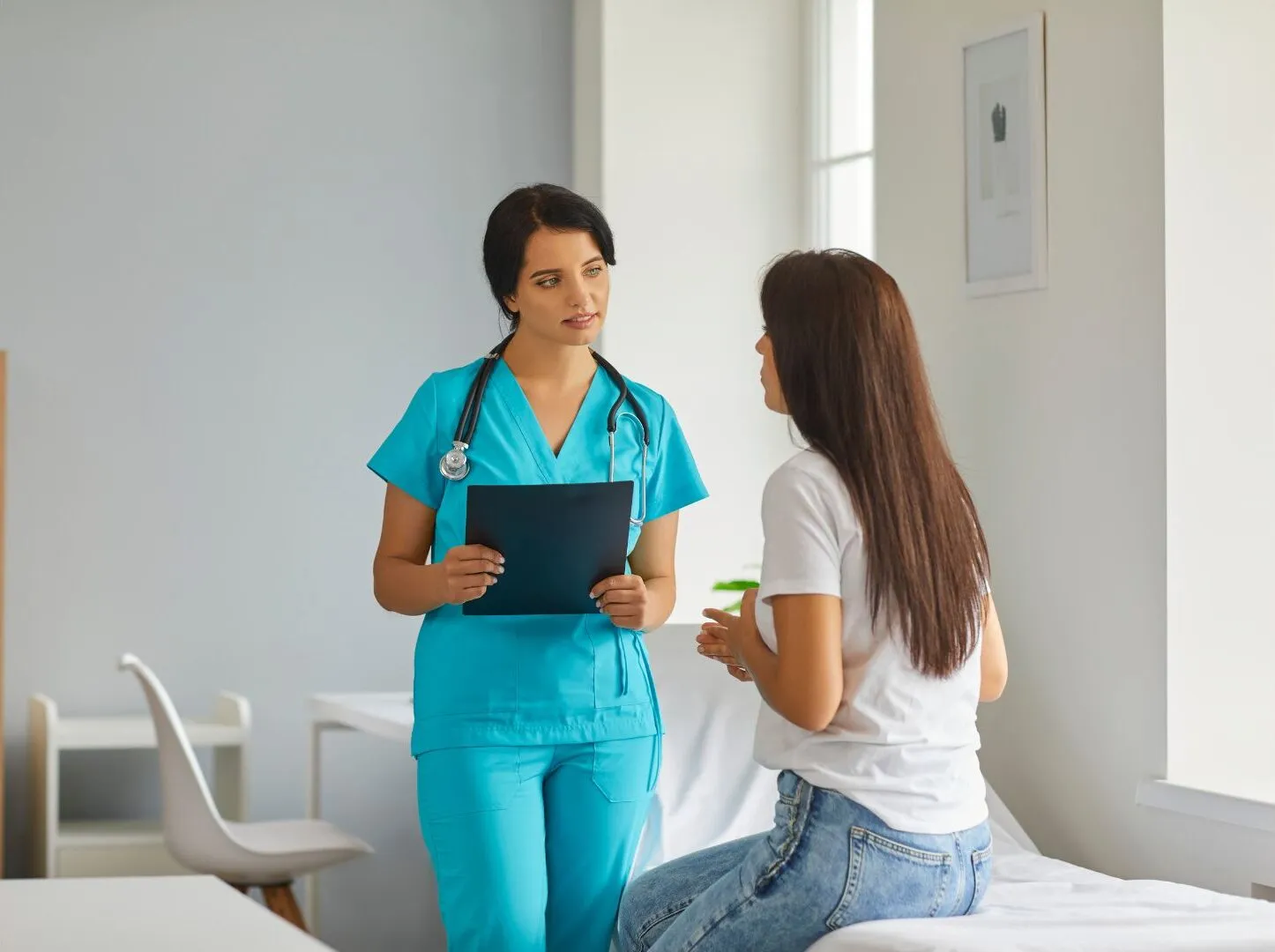 Nurse Explaining Medical Treatment To Female Patient