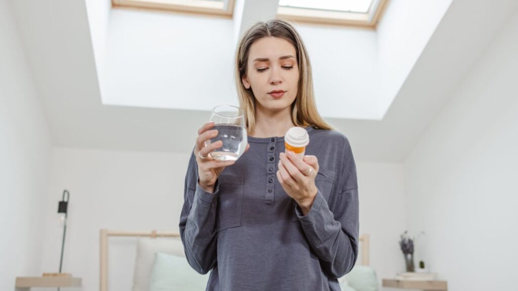 Woman Holding Medication Tablets