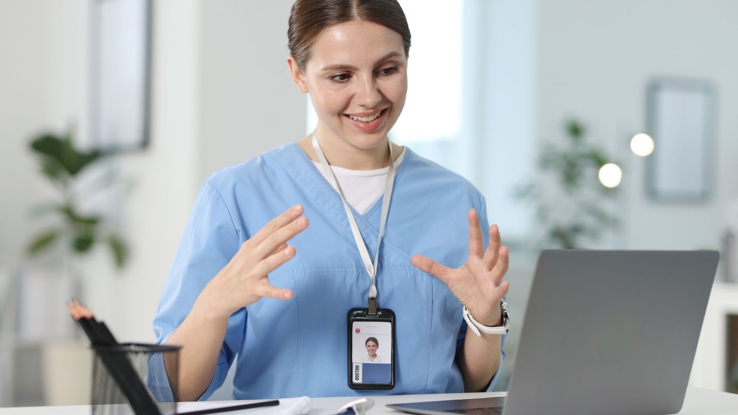 Physician conducting an online video visit from an office