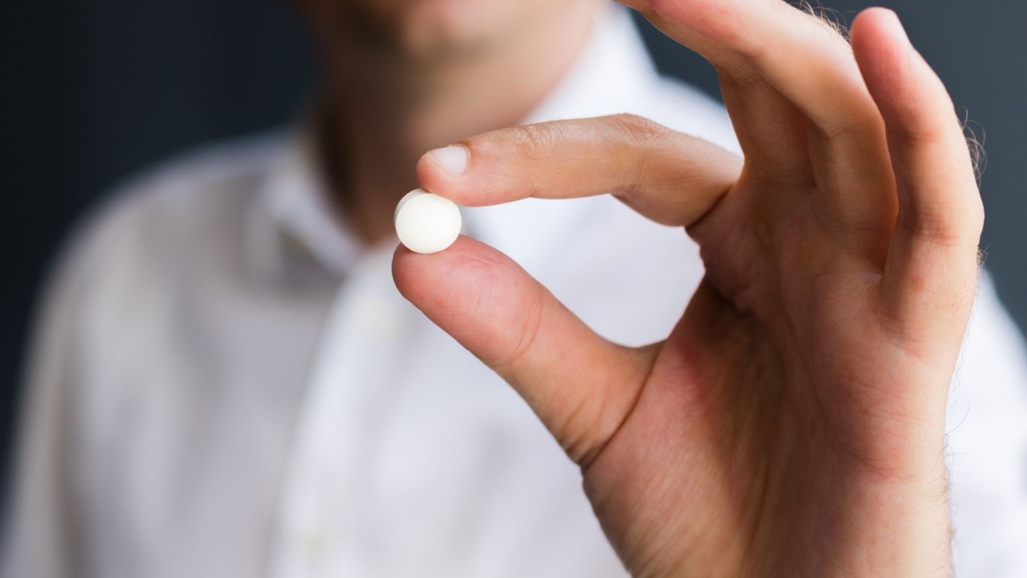 Patient Holding Medication Pill During Benzodiazepine Withdrawal Taper